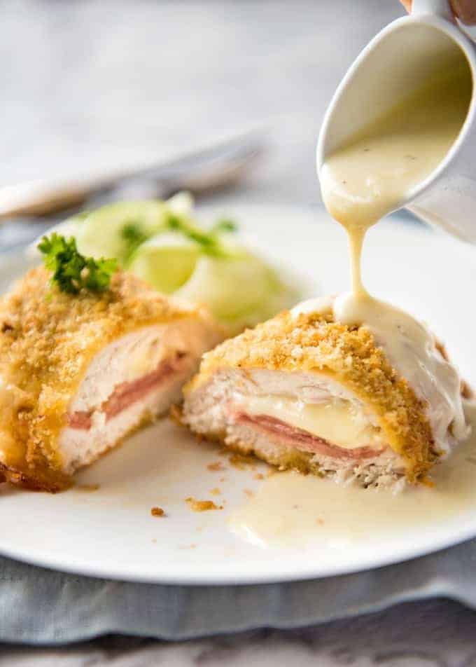 Easy Chicken Cordon Bleu - You are going to be amazed how easy it is to make this chicken stuffed with cheese and ham, coated in crunchy breadcrumbs and served with a gorgeous cheese sauce! www.recipetineats.com