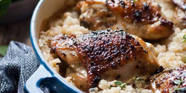 One Pot Creamy Baked Risotto with Lemon Pepper Chicken in a blue pot