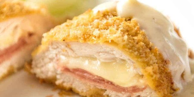 Close up of Dijon Cream Sauce being poured over Easy Chicken Cordon Bleu