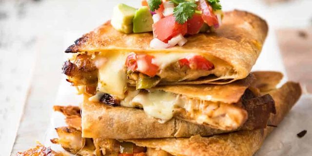Crispy Oven Baked Chicken Quesadillas - This is how to make multiple Quesadillas at the same time! Crispy on the outside, stuffed with Mexican seasoned chicken and capsicum / bell peppers (and cheese of course!) www.recipetineats.com