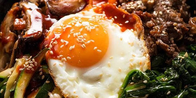 Close up of Bibimbap Korean Rice Bowl with Bibimbap Sauce, ready to be eaten
