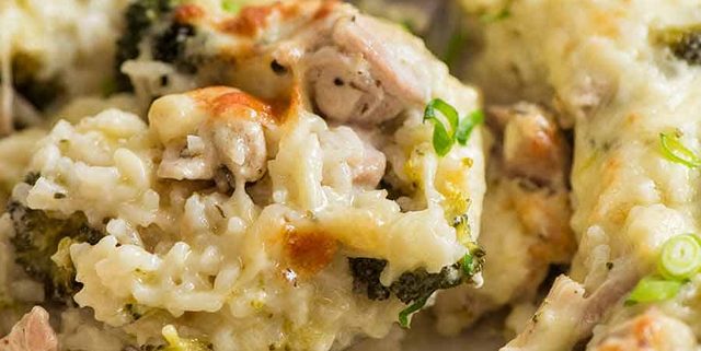Close up of creamy Chicken Rice Casserole in a white baking dish, fresh out of the oven