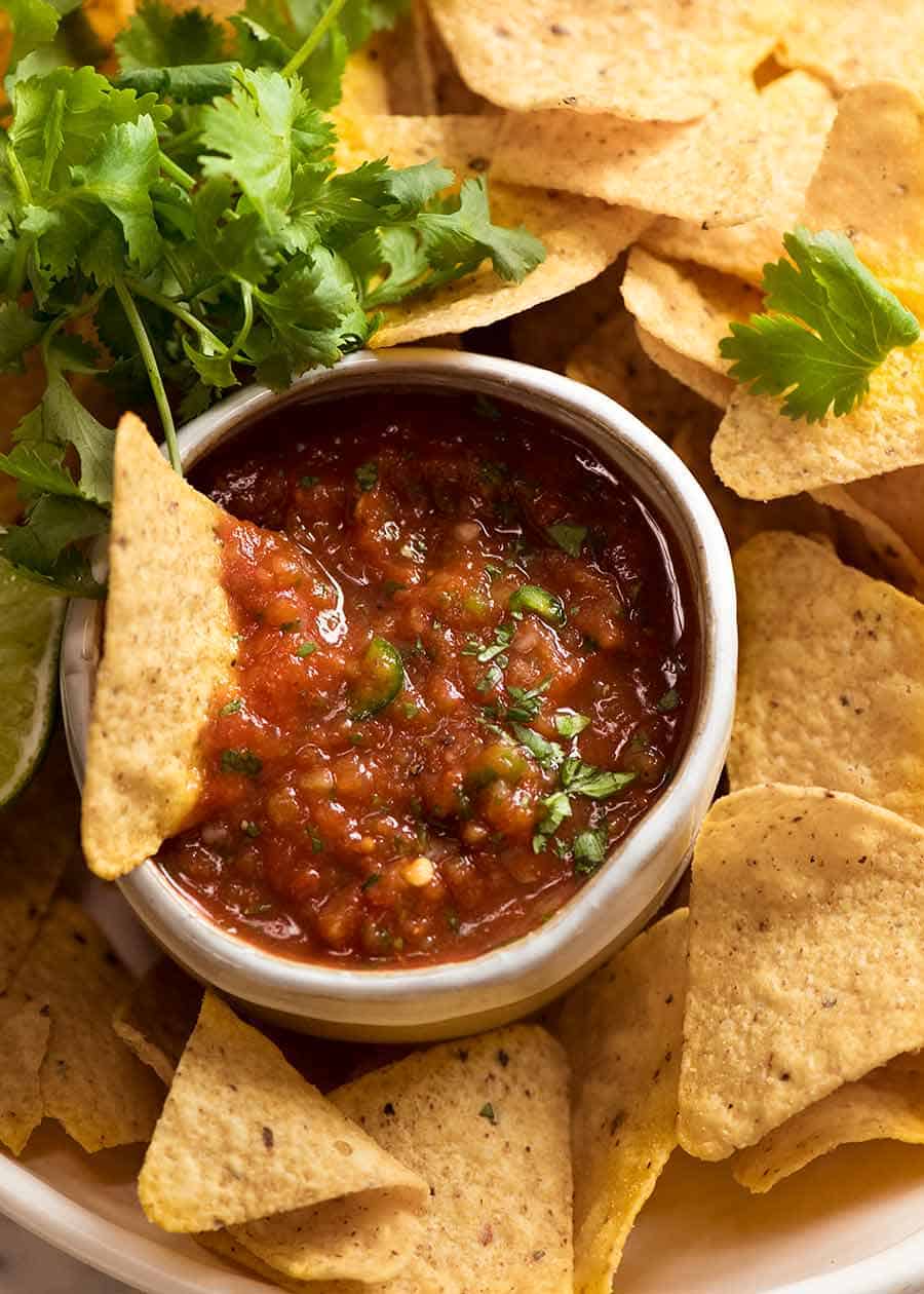 Close up of ceramic bowl with salsa with corn chips