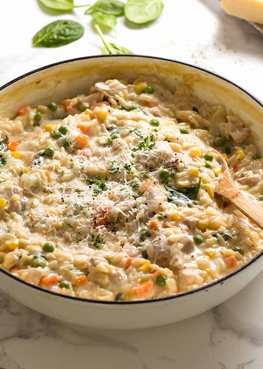 Creamy Chicken Vegetable Risoni in a white skillet, fresh off the stove. Quick chicken dinner recipe!