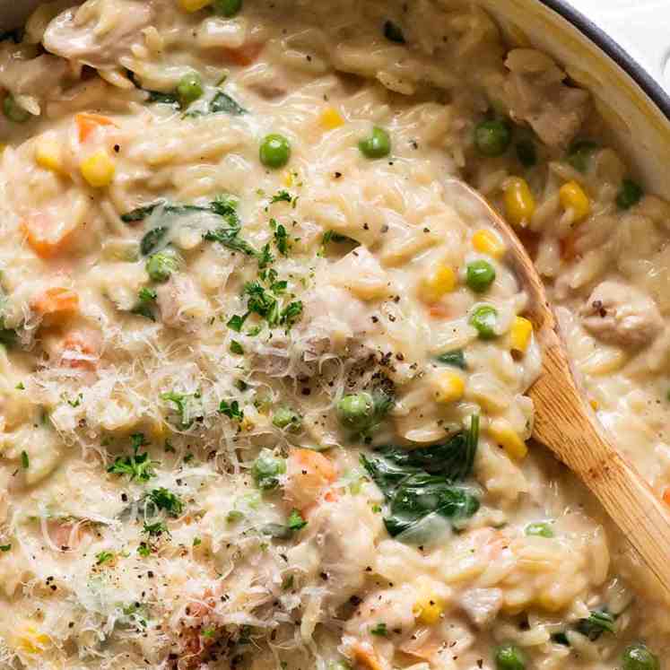 Creamy Chicken Vegetable Orzo in a skillet, fresh off the stove. Quick one pot chicken dinner - 15 minutes!