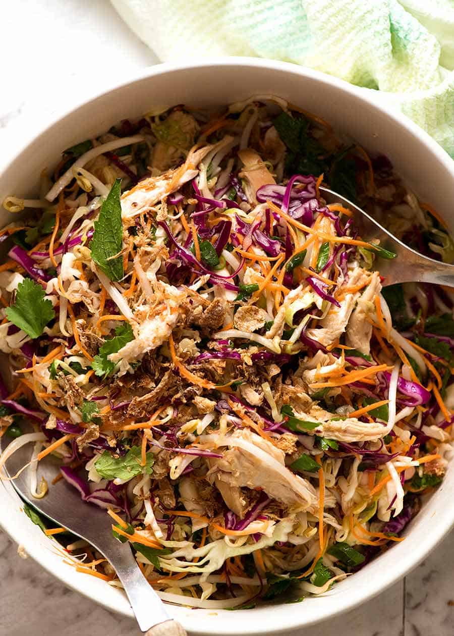 Overhead photo of Asian Slaw with chicken in a white salad bowl, ready to be served