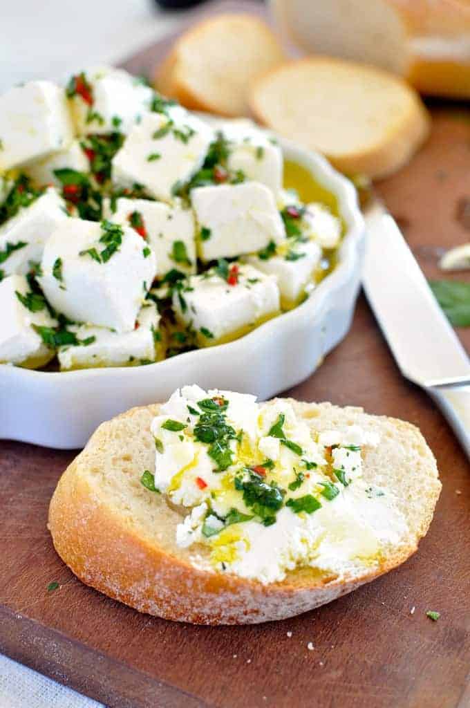 Feta Marinated with Herbs and Chilli spread on bread