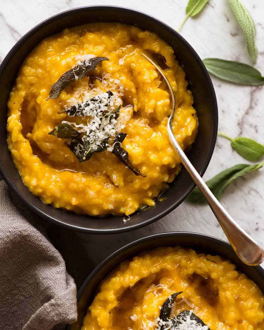 Overhead photo of two black bowls with Creamy Baked Pumpkin Risotto