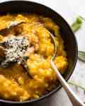 Close up of spoon in a bowl with Creamy Baked Pumpkin Risotto