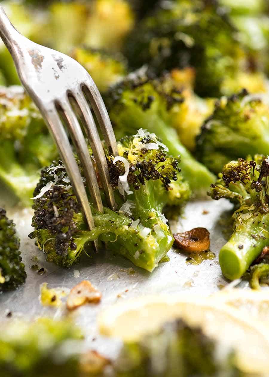 Close up of fork and a piece of Magic Broccoli - the best roasted broccoli ever