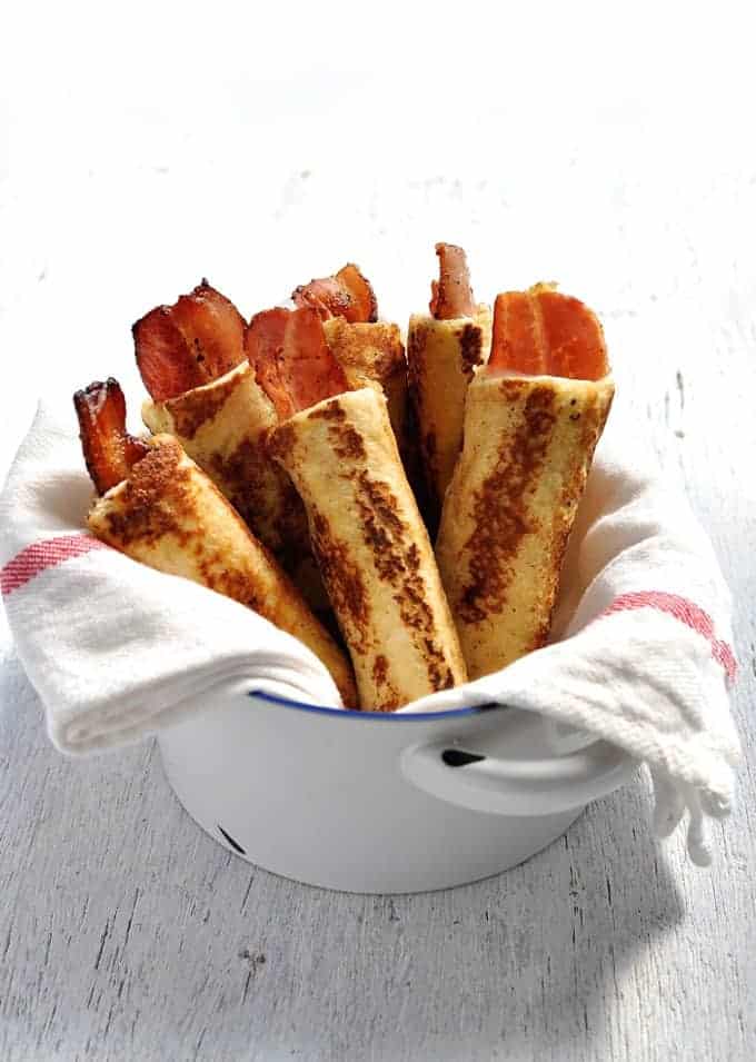 Bacon French Toast Roll Ups - crispy bacon rolled up in bread, dipped in egg mixture and pan fried golden brown. These need to be made with fresh, plain sandwich bread, not fancy artisan bread. #breakfast #brunch #french_toast #bacon #roll_up