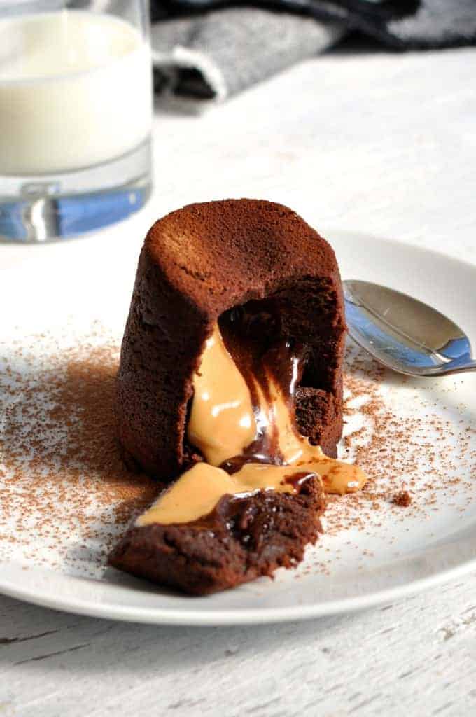 Peanut Butter Chocolate Molten Lava Cake cut open showing the molten peanut butter chocolate centre pouring out.