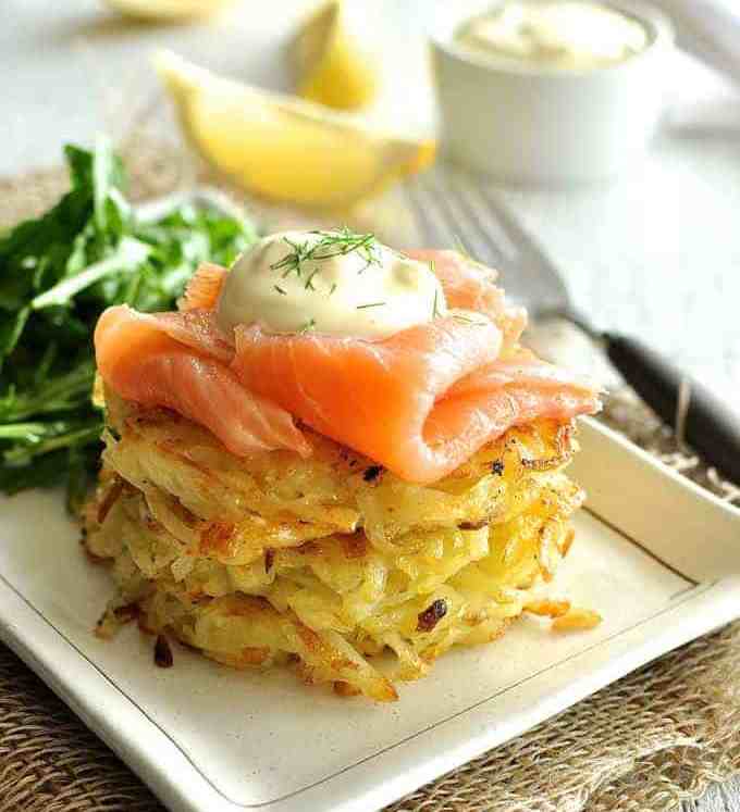 Smoked Salmon Potato Rosti Stack with a rocket salad and lemon wedges on the side