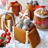 Festive spread of Gingerbread Boxes and Mason Jars tied with ribbons and filled with chocolate truffle balls.