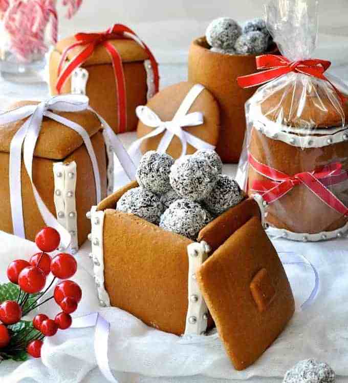 Festive spread of Gingerbread Boxes and Mason Jars tied with ribbons and filled with chocolate truffle balls.