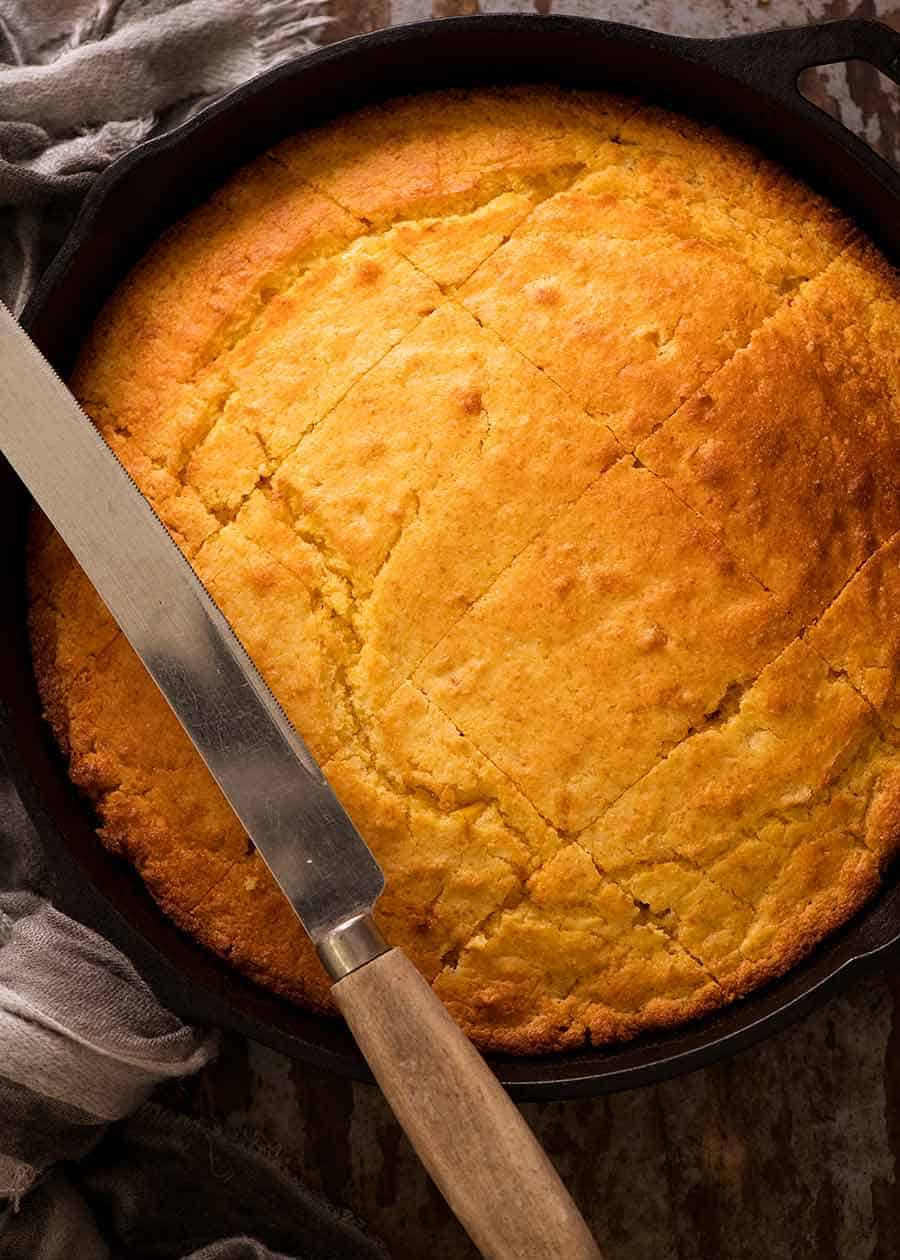 Overhead shot of cornbread in a black skillet, fresh out of the oven