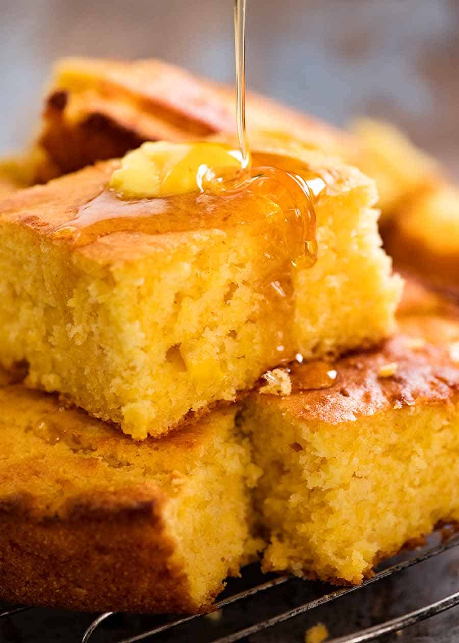 Honey being drizzled on a piece of Cornbread