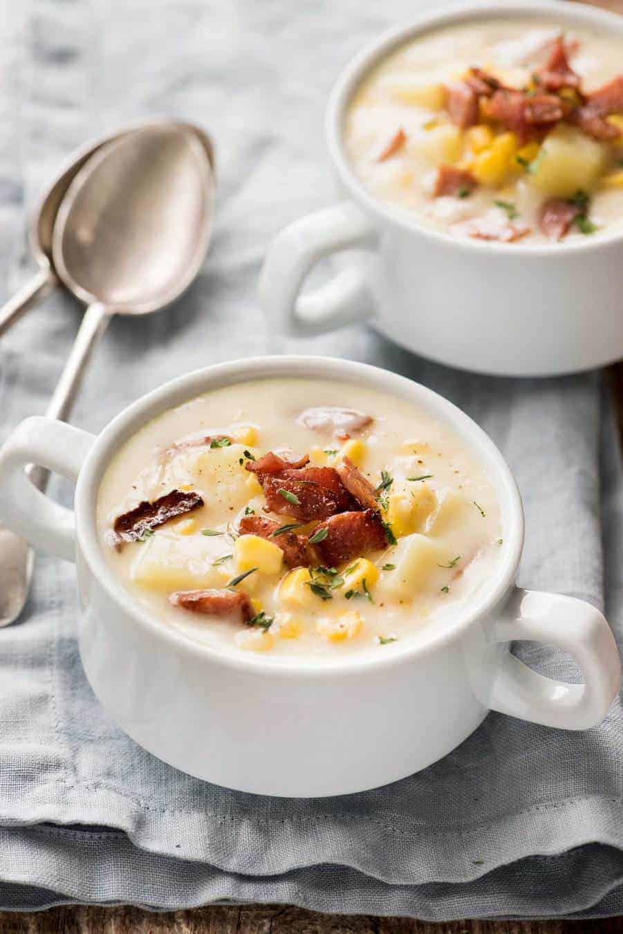 Ham and Corn Chowder in small white soup bowls, ready to be eaten.