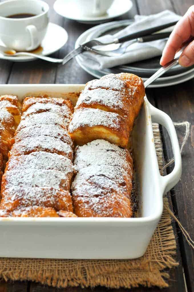 Hasselback Baked French Toast in a baking dish, hot out of the oven and ready to be served.