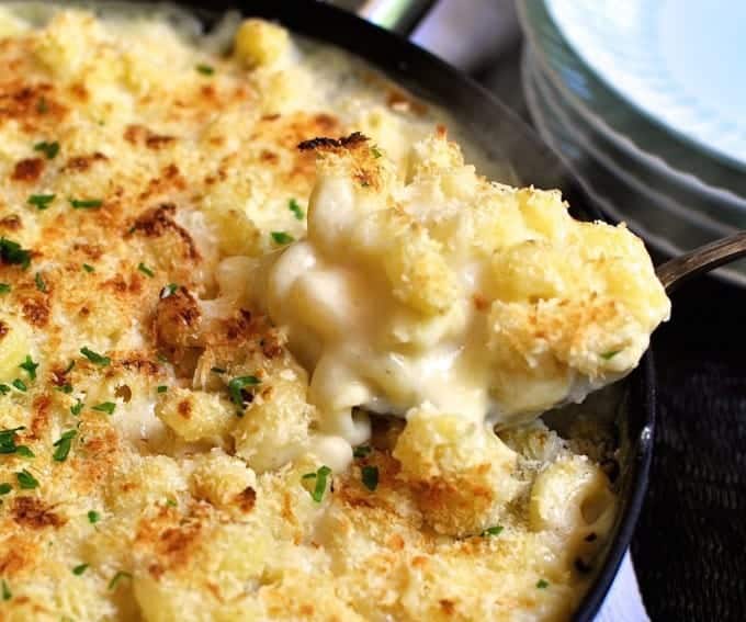 Closeup of Baked One Pot Mac and Cheese being spooned from the pan