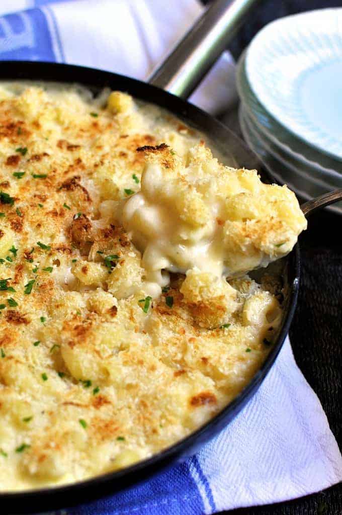 Closeup photo of Baked One Pot Mac and Cheese being spooned from the pan