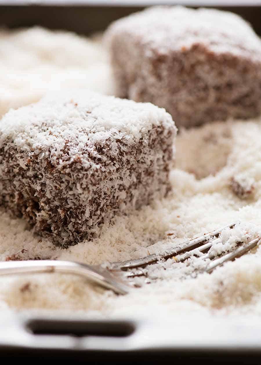 Lamingtons being coated in coconut