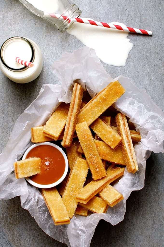 Baked Apple Pie Fries with Salted Caramel Dipping Sauce - everything you love about apple pie, in mini bite size form. Just spread pie filling between pastry, cut and bake. Easy to make, fun to eat!