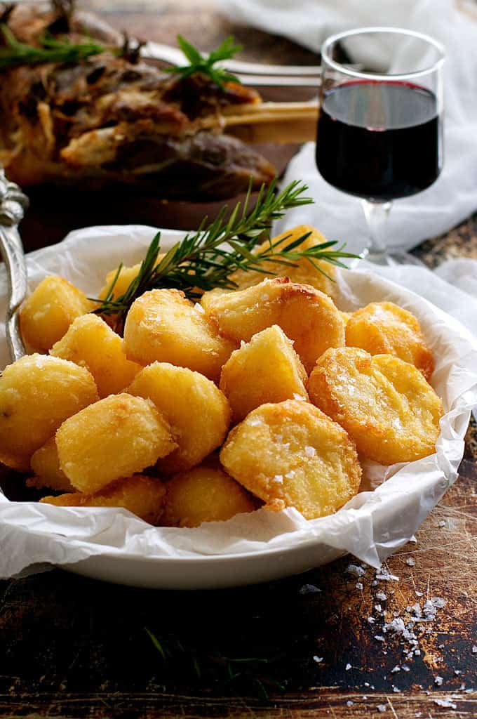 Truly Crunchy Roast Potatoes - this has a really thick, crunchy crust! Par boil, rough up the surface, dust with semolina then bake in a very hot oven in preheated oil. Based on a Nigella recipe.