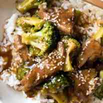 Chinese Beef and Broccoli in rice in a bowl, ready to be eaten.