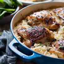 One Pot Creamy Baked Risotto with Lemon Pepper Chicken in a blue pot