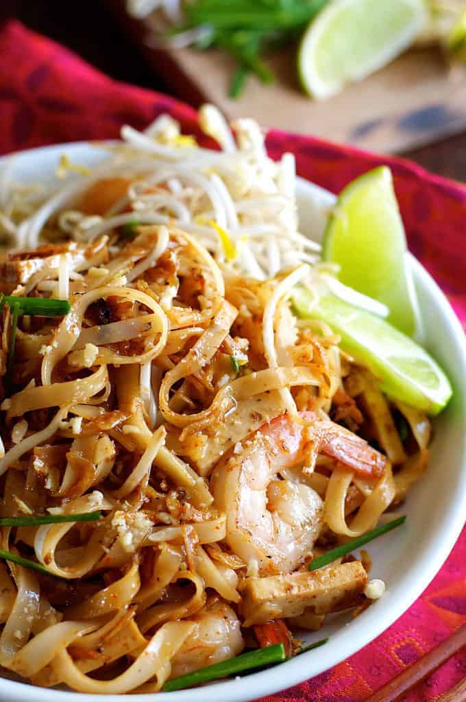 Closeup of Shrimp Pad Thai with lime garnishes