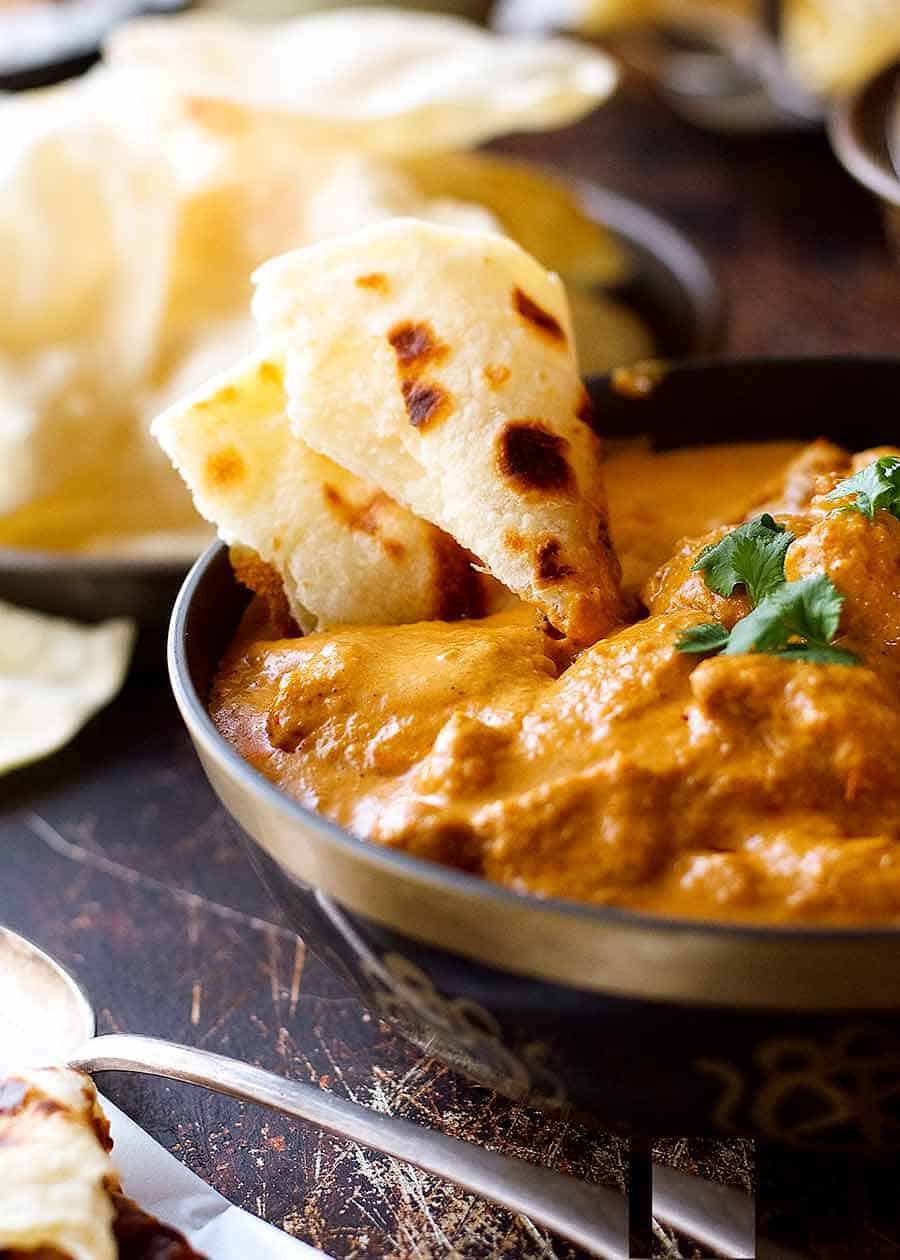 Close up of naan used to scoop butter chicken