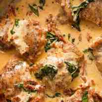 Chicken with Creamy Sun Dried Tomato Sauce in a silver pan, fresh off the stove ready to be served