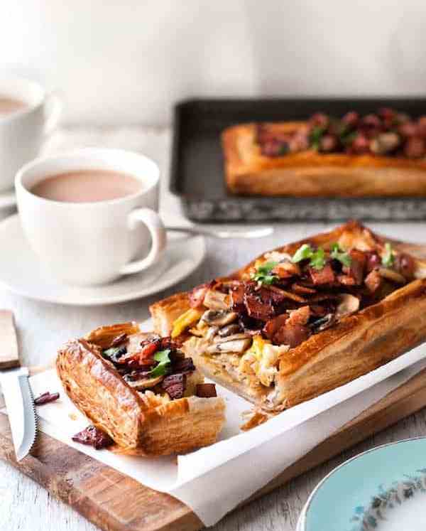 Bacon, Egg and Mushroom Tart on a wooden board, ready to be served.
