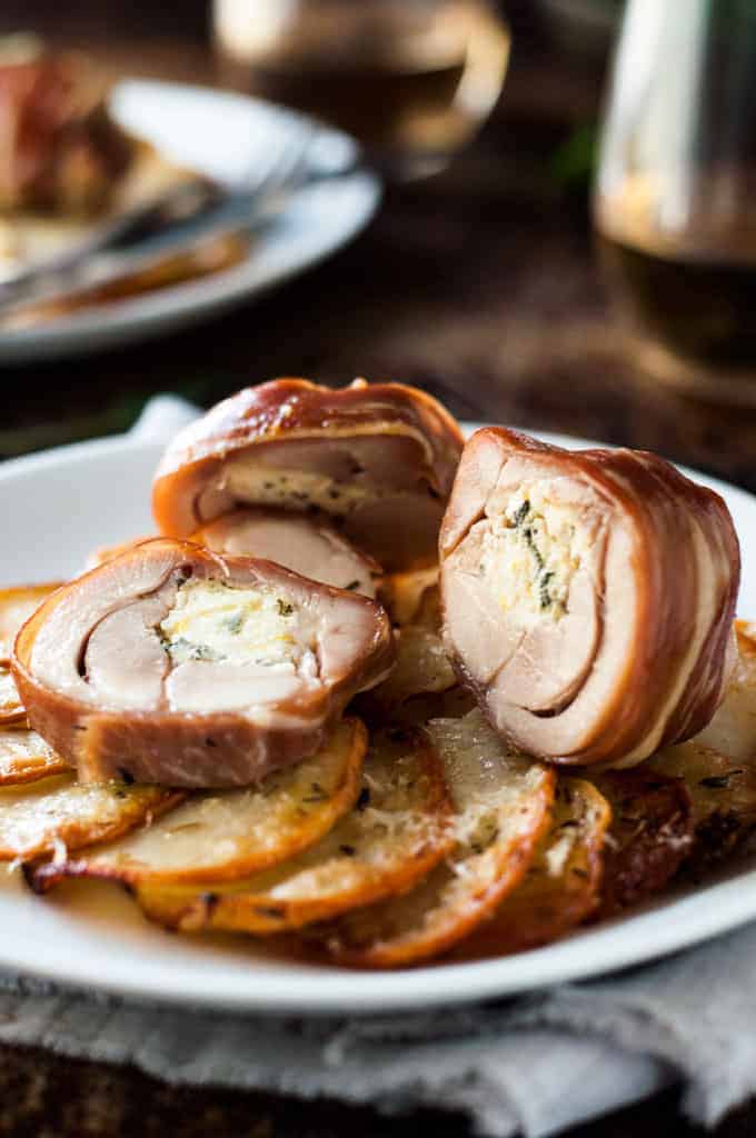 Prosciutto Wrapped Chicken cut open revealing the ricotta filling.