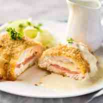 Easy Chicken Cordon Bleu - You are going to be amazed how easy it is to make this chicken stuffed with cheese and ham, coated in crunchy breadcrumbs and served with a gorgeous cheese sauce! recipetineats.com