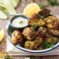 Greek Zucchini Tots / Fritters - transform the humble zucchini into these tasty bites! Easy to make, traditional Greek recipe. #courgette