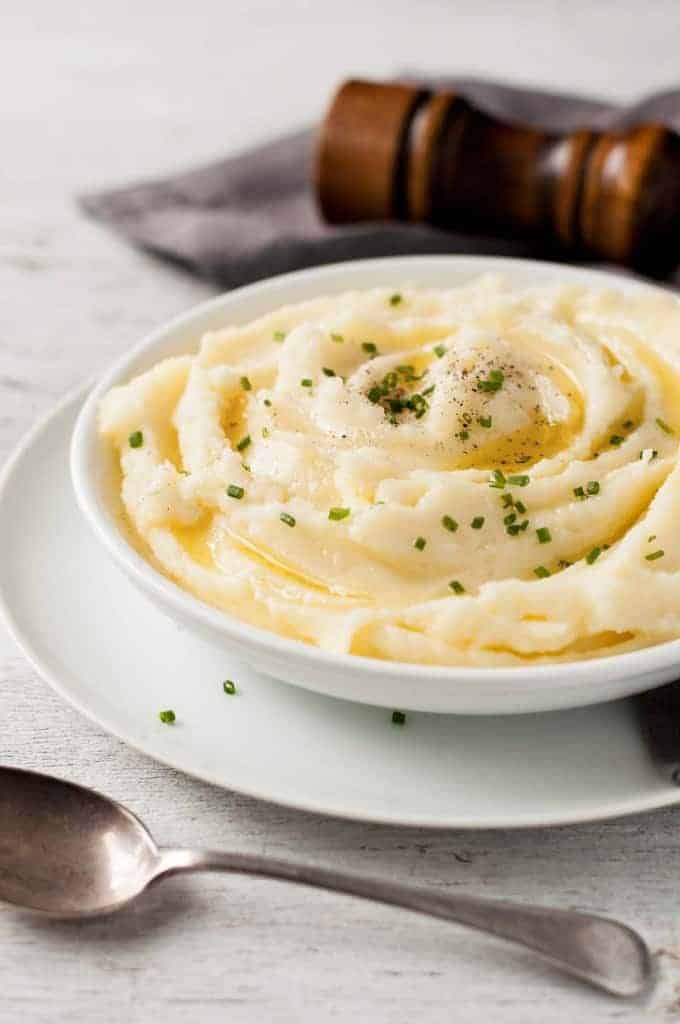 Creamy Make Ahead Mashed Potato in a white bowl, ready for serving.