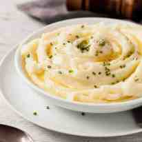 Creamy Make Ahead Mashed Potato in a white bowl, ready for serving.