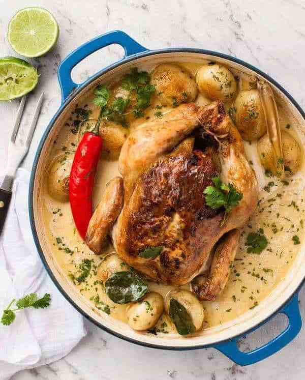Whole pot roasted chicken in fragrant coconut broth