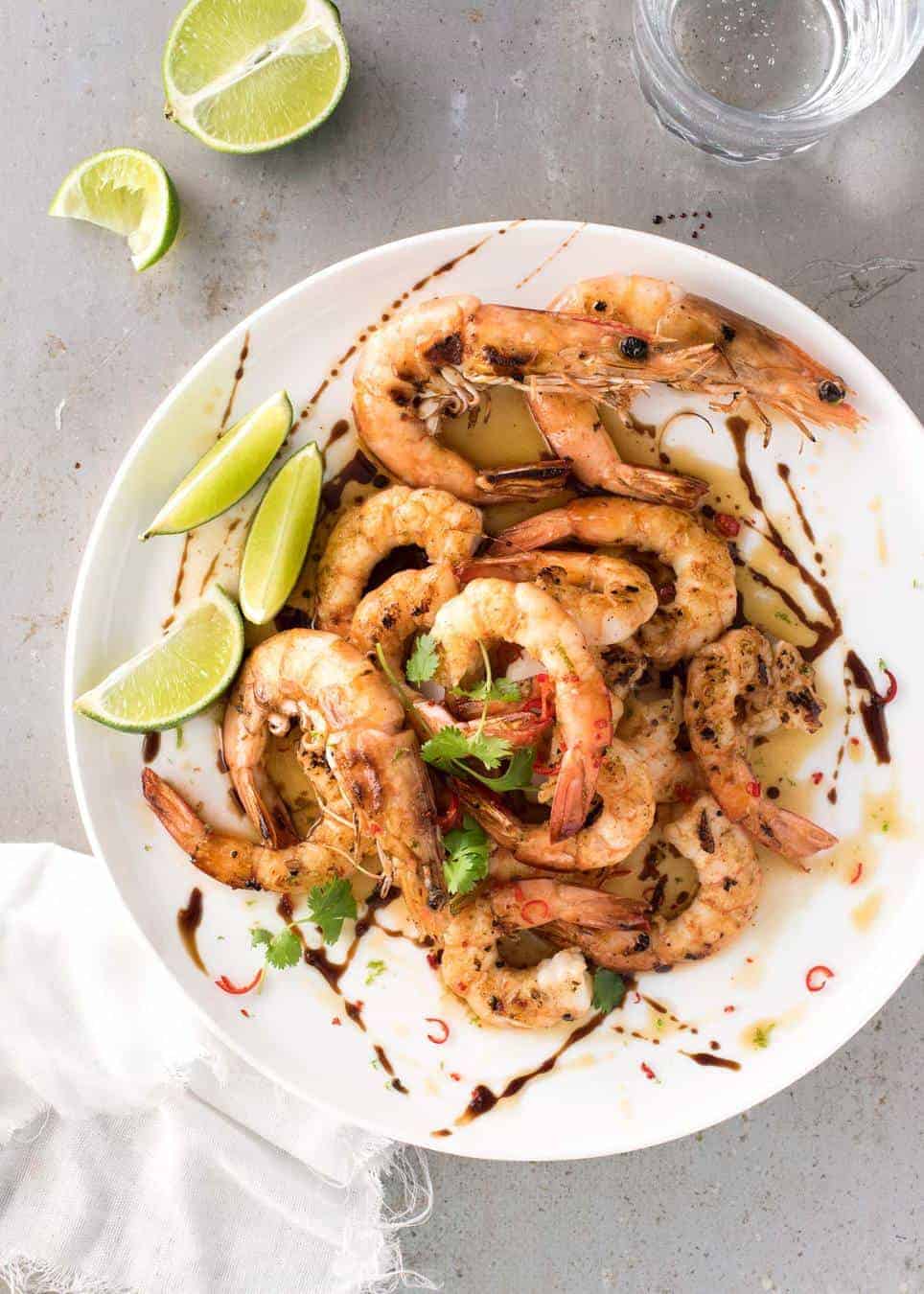 Asian Grilled Shrimp / Prawns on a white plate, with fresh lime on the side.