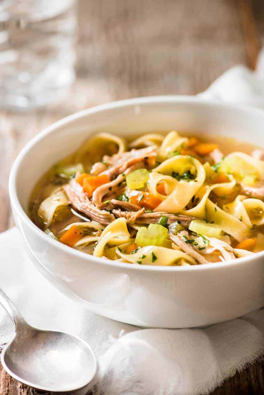 Chicken Vegetable Noodle Soup in a white bowl, ready to be eaten.