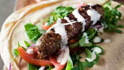 Turkish Lamb Kebab Kofta on pita with vegetables and yoghurt sauce