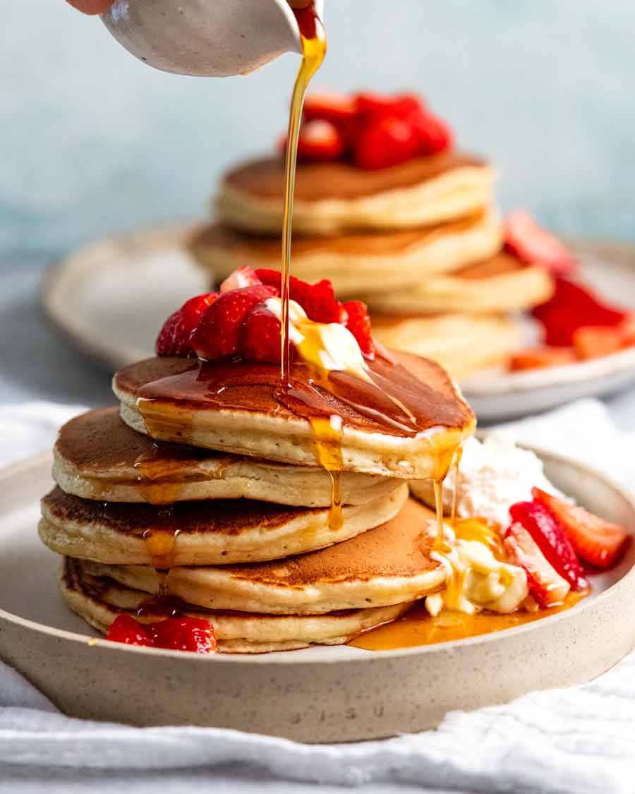 Pouring syrup over Ricotta pancakes