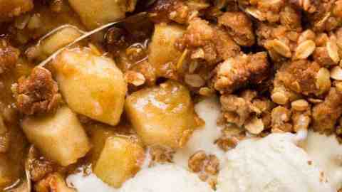 Close up overhead photo of Apple Crumble with scoops of vanilla ice cream