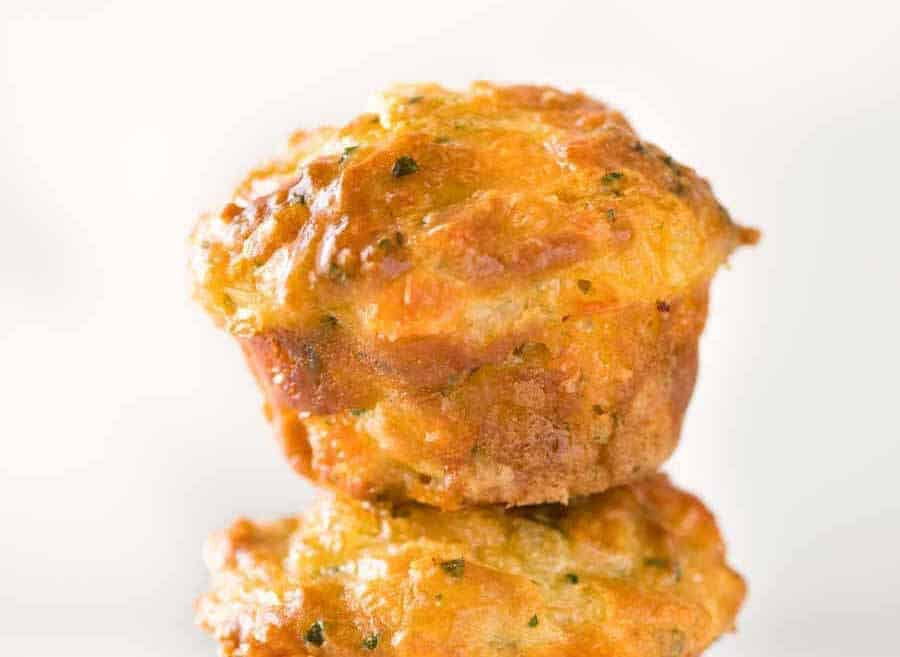 Close up photo of a savory cheese muffin with a golden dome.