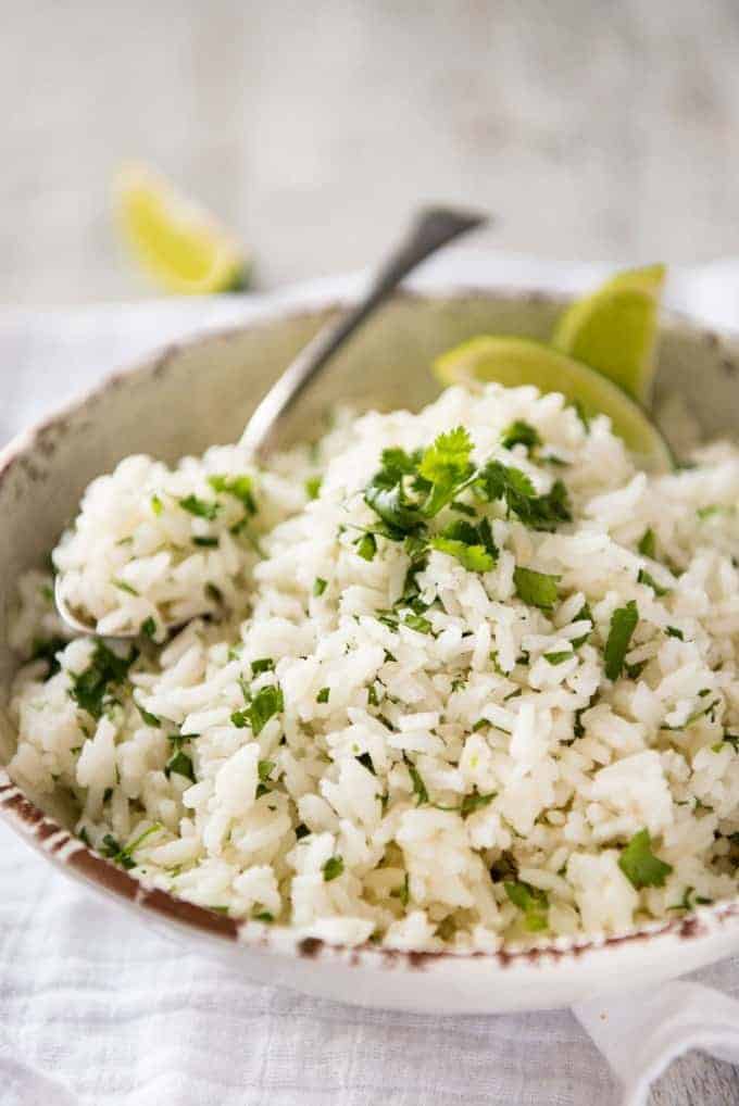 Coconut Cilantro Lime Rice in a bowl with a spoon, ready to be served.