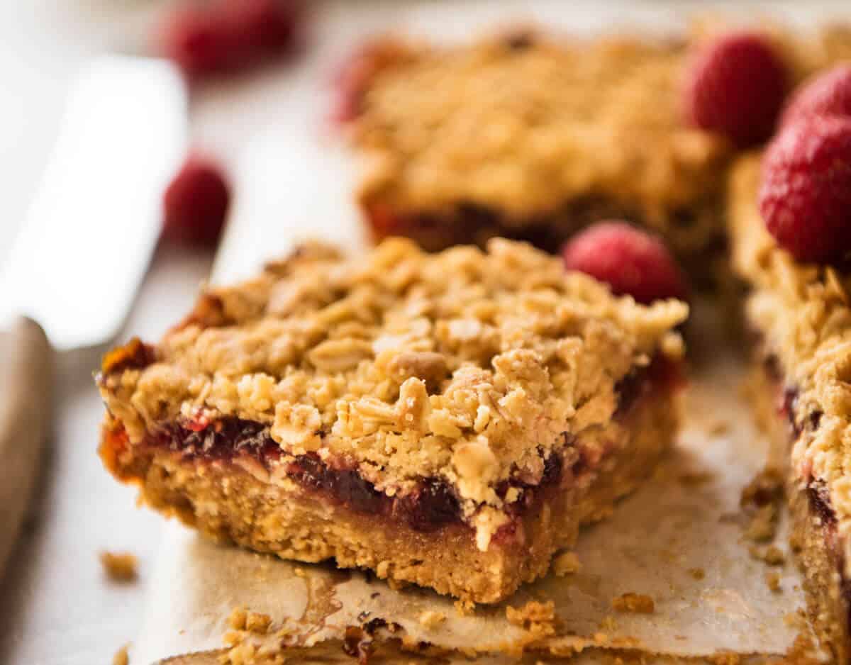 Raspberry Bars - One of the fastest bars to make from scratch, these have an oatmeal biscuit base, raspberry jam and a crumbly oatmeal topping. Just 10 minutes prep! www.recipetineats.com