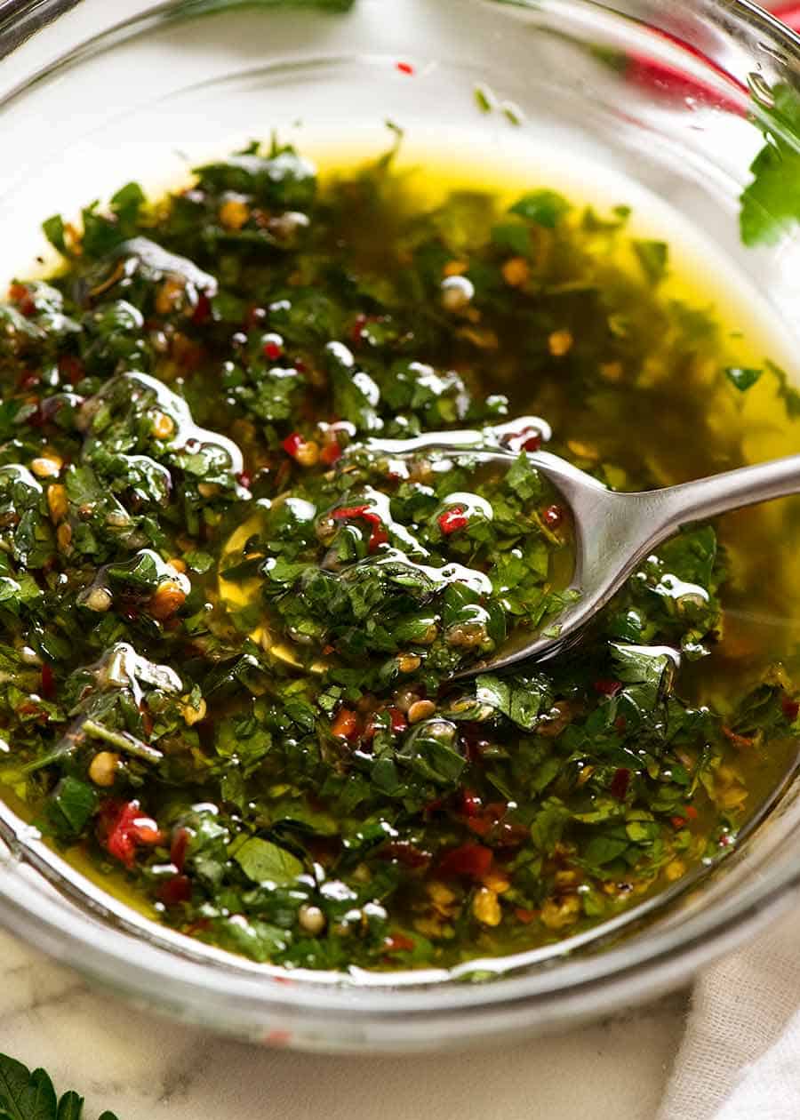 Close up of spooning Chimichurri Sauce