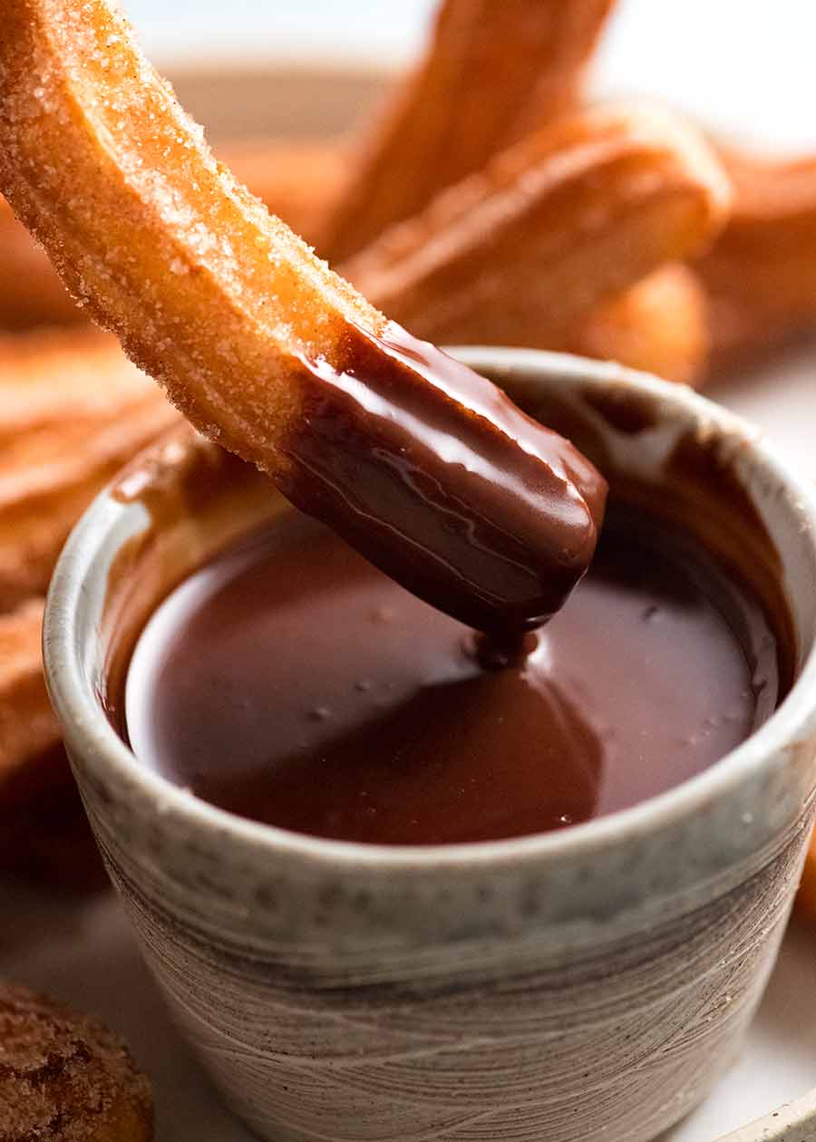 Dipping churros into chocolate sauce
